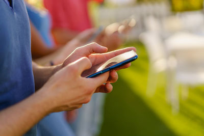 Midsection of man using mobile phone