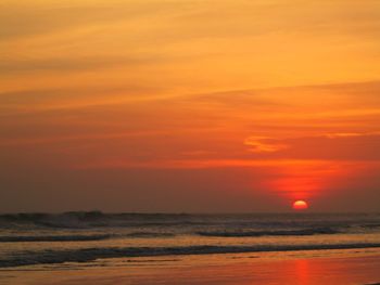 Scenic view of sea against romantic sky at sunset