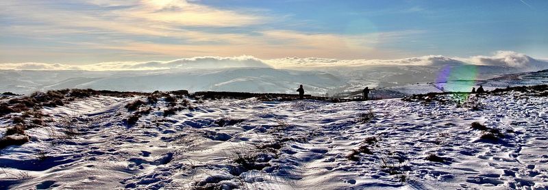 Scenic view of snow covered mountains against sky