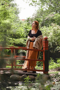 Happy ginger hair woman in well-groomed park or garden. freedom and healthy way of life. female in