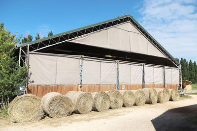 Hay bales on field against sky