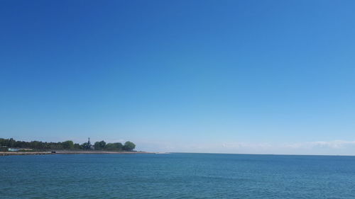 Scenic view of sea against clear blue sky