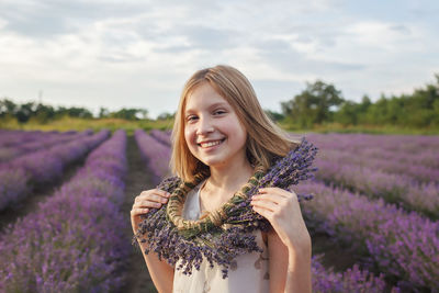 Beautiful young woman with yellow flower in field