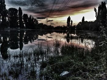 Scenic view of lake against sky at sunset