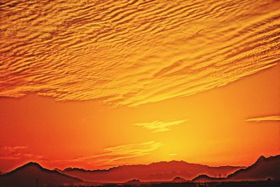 Scenic view of mountains against orange sky