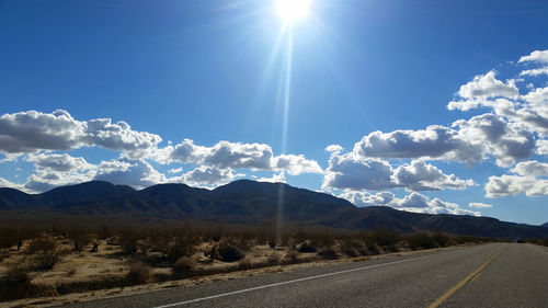 Country road leading towards mountains