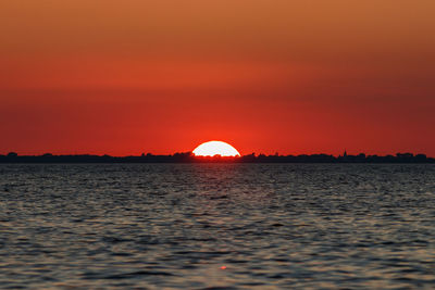 Scenic view of sea against romantic sky at sunset