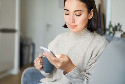 Young woman using mobile phone