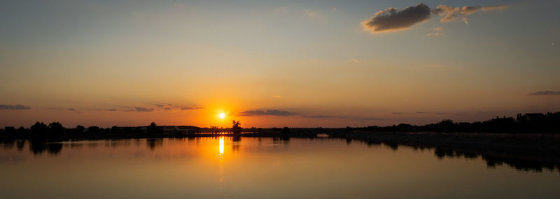 Scenic view of lake against sky during sunset