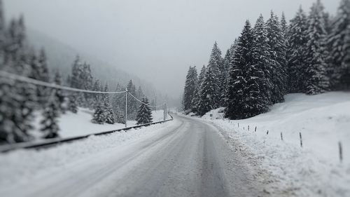 Road passing through snow covered landscape
