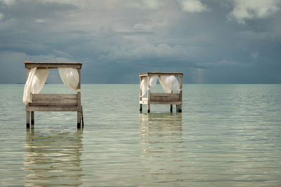 Lifeguard hut in sea against sky