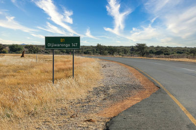 Road sign against sky