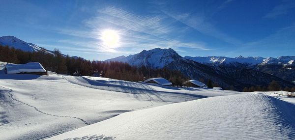 Scenic view of snow covered mountains against sky