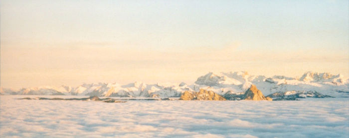 Frozen landscape against sky during winter