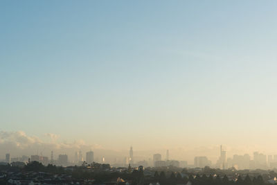Far view of kuala lumpur city skyline in a hazy and misty morning