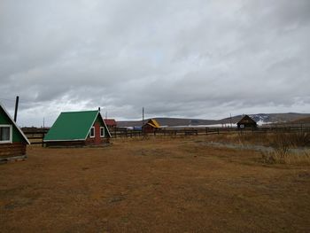 Houses on field against sky