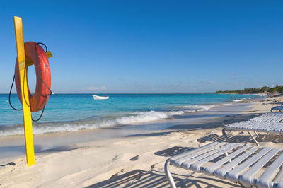 Scenic view of beach against clear blue sky