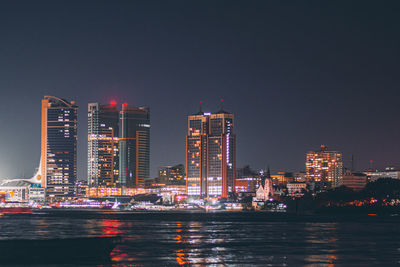 Illuminated buildings in city at night