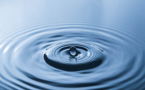 High angle view of drop falling on water