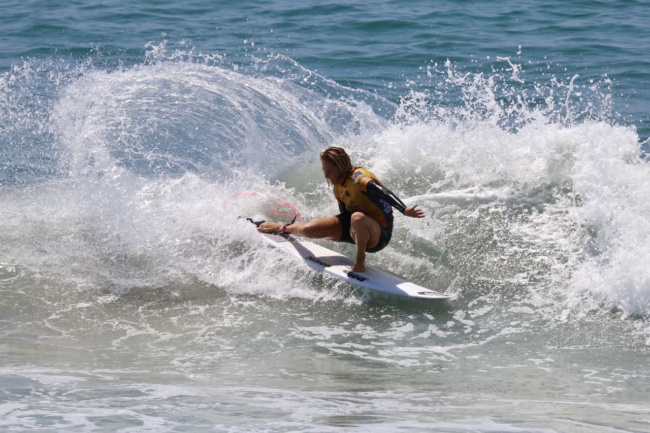 MAN SURFING ON SEA WAVES