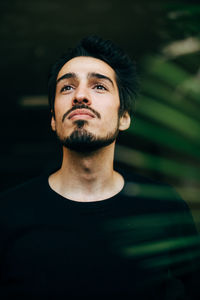 Portrait of young man looking up