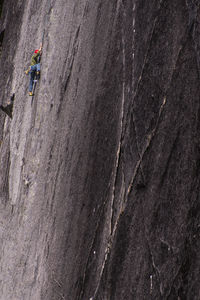 Man rock climbing big granite blank rock face in squamish chief bc