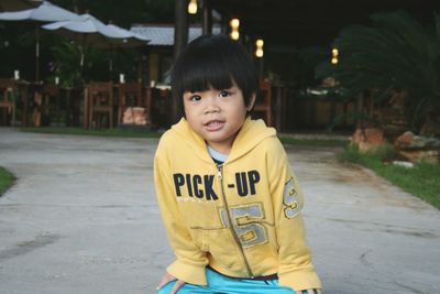 Portrait of boy sitting at park