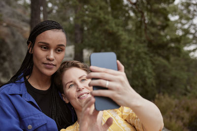 Female couple taking selfie outdoors