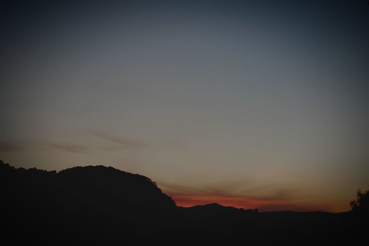 silhouette, tranquil scene, sunset, scenics, tranquility, beauty in nature, mountain, copy space, nature, sky, landscape, idyllic, dark, dusk, mountain range, outline, outdoors, non-urban scene, clear sky, majestic