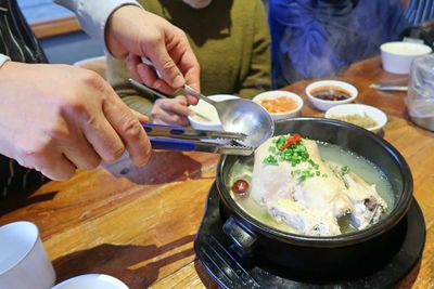 Midsection of man preparing food on table