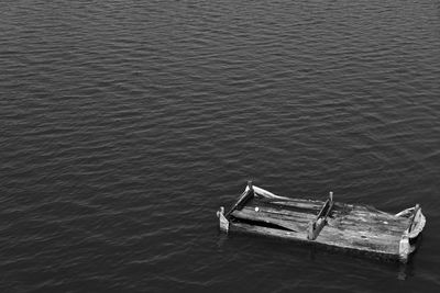 Damaged wooden raft in sea