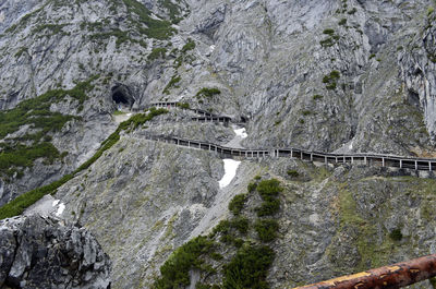 Bridge over water against rock formation