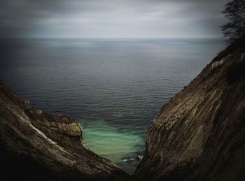 Scenic view of sea by mountain