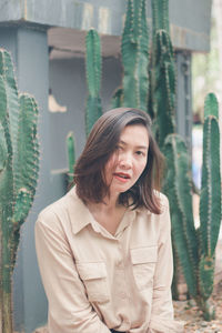 Portrait of beautiful young woman standing outdoors