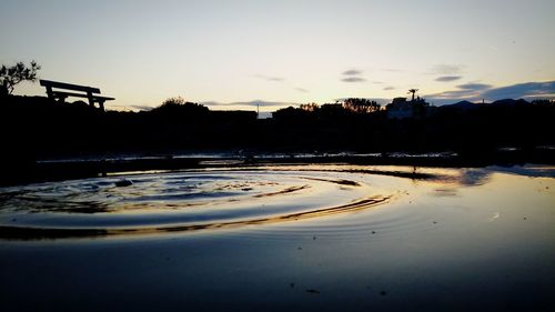 Scenic view of lake against sky at sunset
