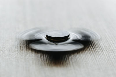 Close-up of spinning fidget spinner on table