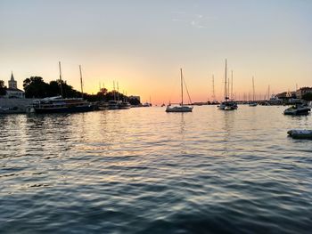 Sailboats moored on sea