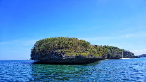 Scenic view of sea against clear blue sky