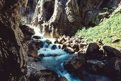 Stream flowing through rocks in forest