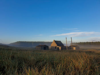 Houses on field against sky
