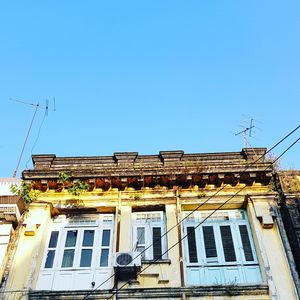 Low angle view of building against clear blue sky