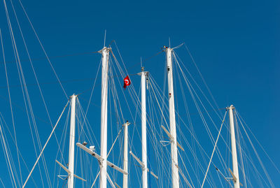 Ship mast in the port of bodrum, turkey in front of cloudless sky