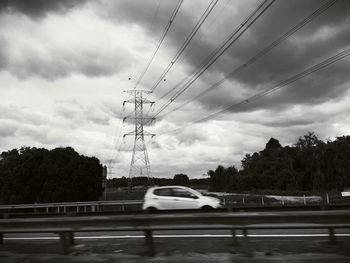 Cars on road against sky