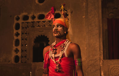 Full length of man standing against wall in building