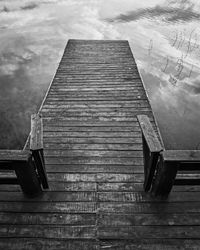 Low angle view of staircase against cloudy sky