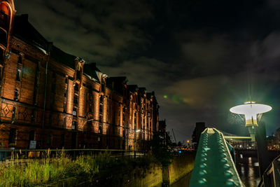 Low angle view of illuminated buildings against sky at night