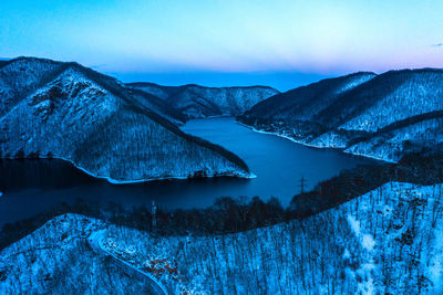 Aerial drone view of a lake at winter during the blue hour