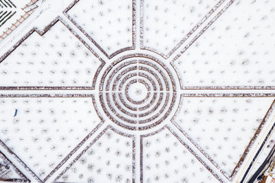 High angle view of snow covered footpath in city during winter