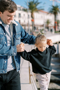 Side view of boy holding hands