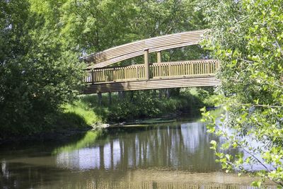 Built structure in lake against trees in forest